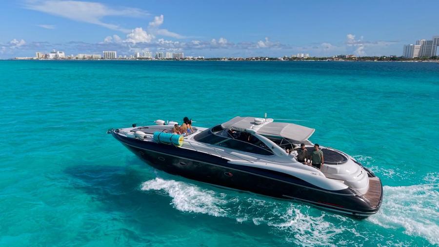 Boat rental Isla Mujeres yacht departing from Marina Cancun into clear blue water